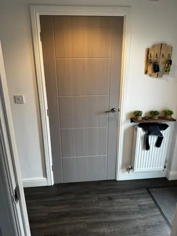 Timber internal door with a lever handle and white architrave